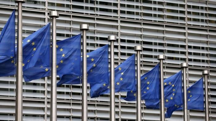 European Union flags flutter outside the EU Commission headquarters in Brussels, Belgium, October 28, 2015.