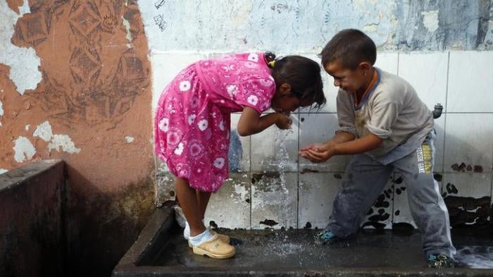 Roma refugees from Kosovo drink water at the Vrela Ribnicka camp in Podgorica, Montenegro on October 13, 2012