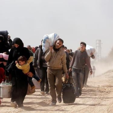 People walk with their belongings as they flee the rebel-held town of Hammouriyeh, in the village of Beit Sawa, eastern Ghouta, Syria March 15, 2018. REUTERS/Omar Sanadiki