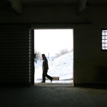 A Romanian journalist walks past a building on the Mihail Kogalniceanu Airbase, 250km (155 miles) east of Bucharest, cited as a possible location for the transfer of terrorist suspects by the CIA. December 19, 2005.