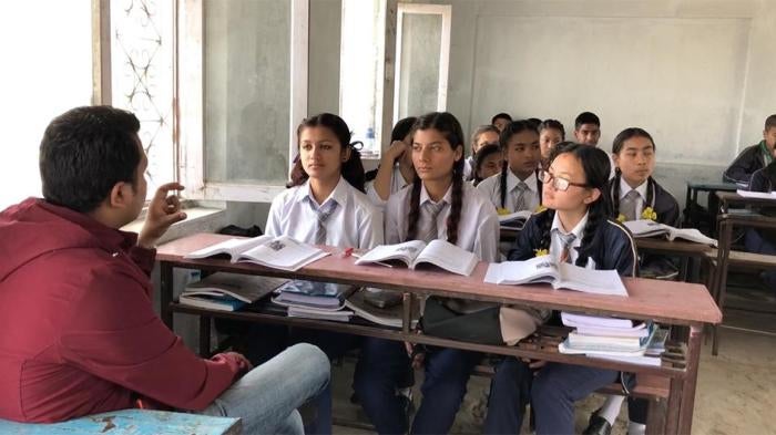 A sign language teacher translates a lesson to students with disabilities in an inclusive class.