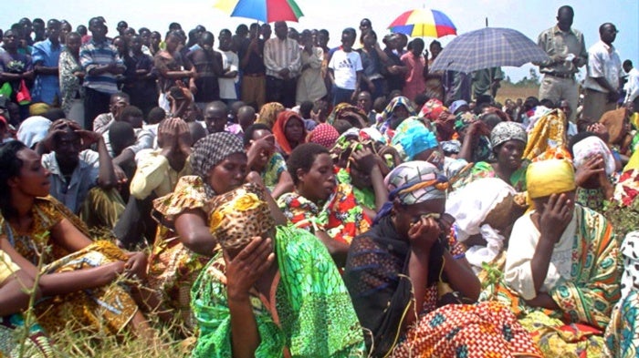 Mourners gather during a mass funeral service for the more than 150 Congolese who were massacred the previous weekend, at Gatumba, a UN-run refugee camp in Burundi, August 16, 2004.