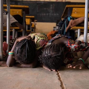 Young girls hide under a desk