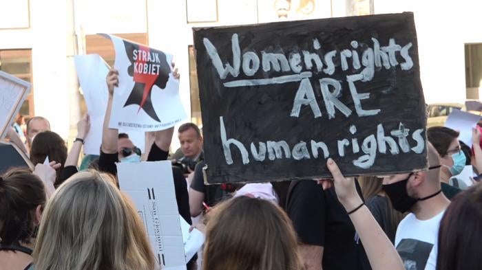 Protesters for Women's rights in Poland raise signs