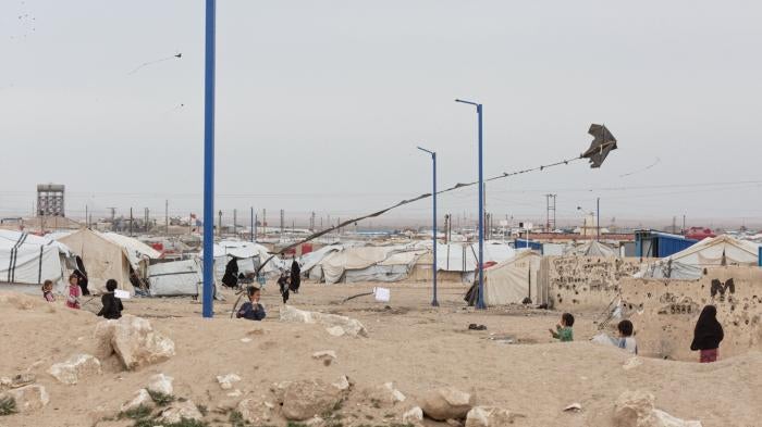 Children fly a kite at al-Hol camp in northeast Syria. 