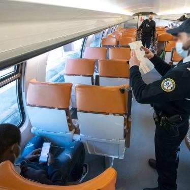 A member of the French border police checks identity documents in March 2021 at the Menton-Garavan station, the first French train station for those travelling between Genoa, in Italy, and Nice, in France.