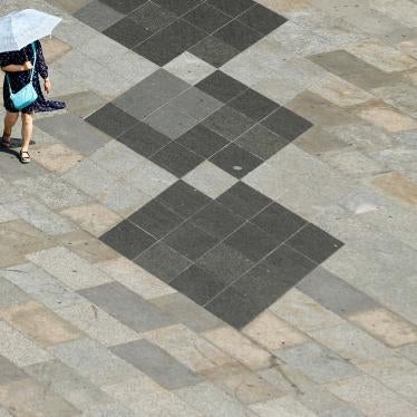 A woman shields herself from the sun with an umbrella on a hot summer day in Cologne, Germany, July 25, 2019. 