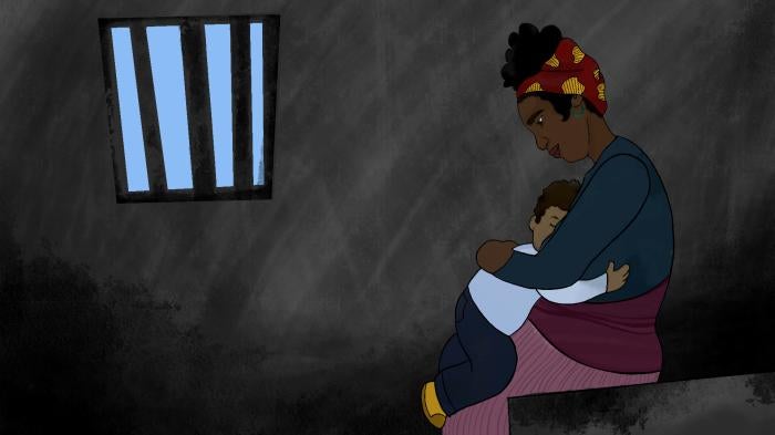 Mother holds child in prison cell