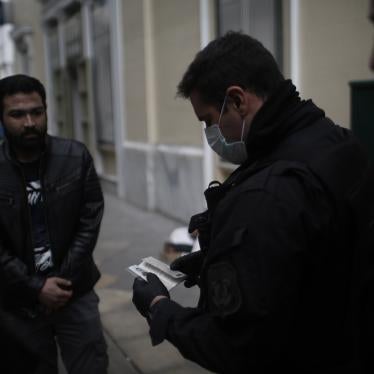 Police officers check the documents and permissions of people in the streets of Athens, Greece, March 23, 2020. 