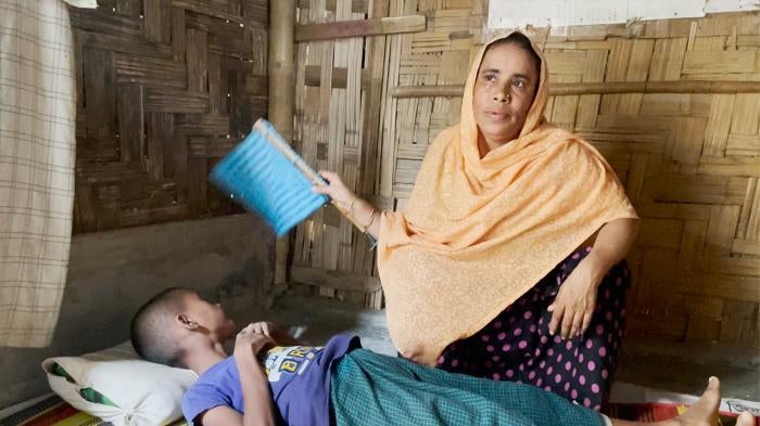 Hasina Hatu at home with her child, Cox's Bazar, Bangladesh