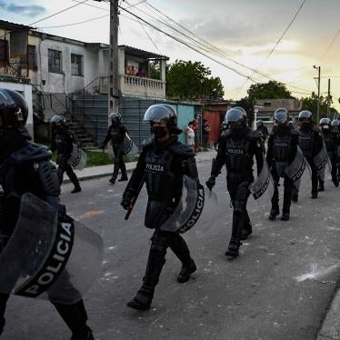 A line of policeman walking down a street