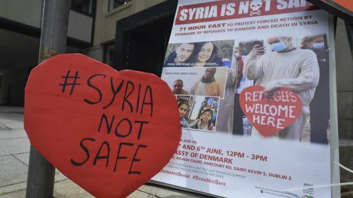 A protest sign that reads "#Syria Not Safe"