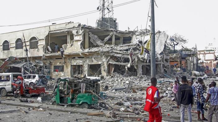 A destroyed building and vehicles after a double car bomb attack at a busy junction in Mogadishu, Somalia.