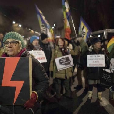 Woman holds a Women's Strike symbol during protest against what they view as an erosion of women’s rights under Poland’s conservative ruling party, Warsaw, Poland, November. 28, 2022 