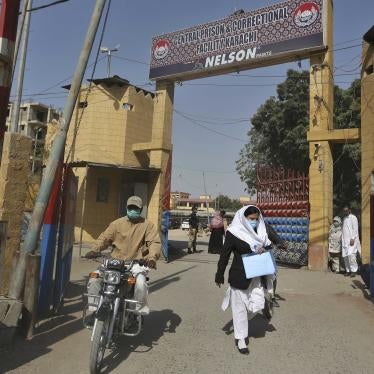 people exit the main entrance of the Karachi Central Prison