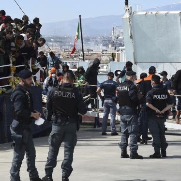 People disembark from a rescue ship in the Italian port of Catania.