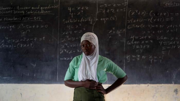 A student poses for a portrait in the classroom of her school in Koidu, Kono district, Sierra Leone, on November 24, 2020. 