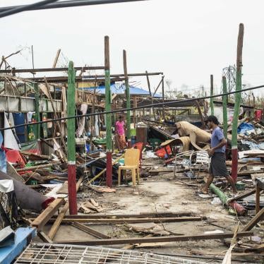  Local residents walk past damaged buildings after Cyclone Mocha in Sittwe township, Rakhine State, Myanmar, May 16, 2023. 