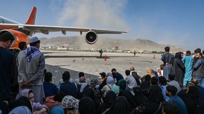 Afghans waiting to leave Afghanistan from Kabul’s international airport after the Taliban takeover, August 16, 2021.