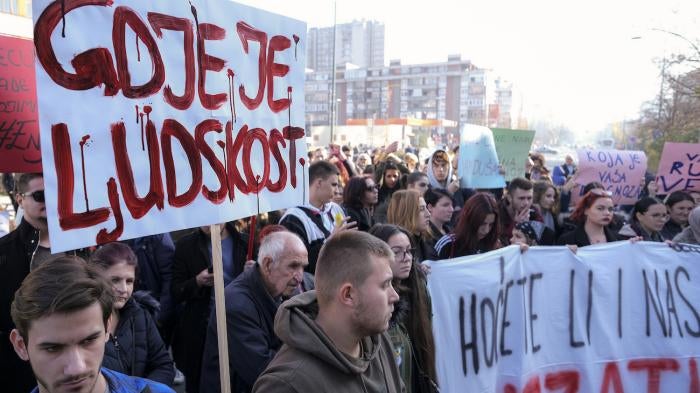 A man holds a banner that reads "Where is Humanity" during a protest following the release of disturbing photos from the Pazaric care home, Sarajevo, Bosnia, November 22, 2019. 