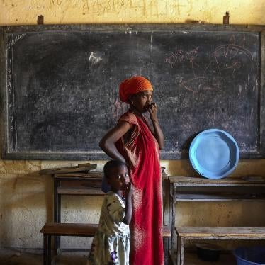 A woman looks out onto the street with her daughter inside a center for internally displace people in Abiy Adi, Tigray, Ethiopia, August 14, 2023. 