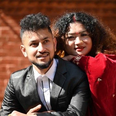 An LGBTQ couple, Surendra Pandey (left) and Maya Gurung, a transgender woman, pose for pictures after obtaining their marriage certificate in Kathmandu, Nepal, December 1, 2023.