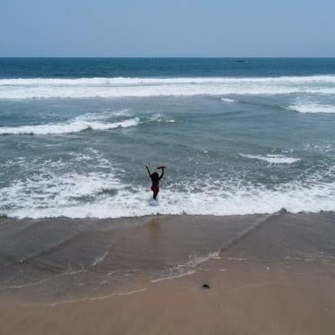 Abena, a young woman with a psychosocial disability, walks along the seashore in Accra, Ghana.