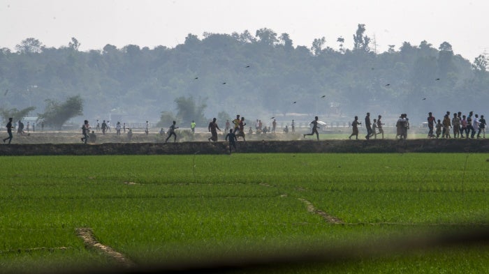 Villagers flee fighting between Myanmar security forces and the Arakan Army near the Bangladesh-Myanmar border in Cox's Bazar district, Bangladesh, February 6, 2024.