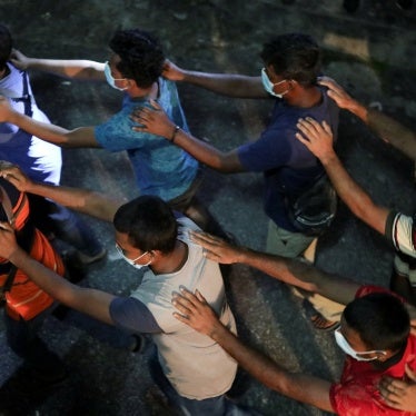 Undocumented migrants walk in line while being detained during an immigration raid in Kuala Lumpur, Malaysia, July 1, 2022.