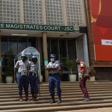 Police officers outside the Magistrates Court in Harare, Zimbabwe, April 6, 2021.