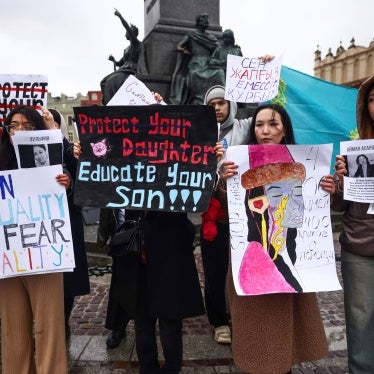 Demonstrators hold protest signs