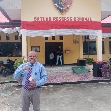 Yan Christian Warinussy outside the Manokwari criminal investigation unit, West Papua, Indonesia.