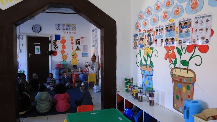 A teacher gives lessons to children at an early learning center in De Aar Town, South Africa, August 11, 2023.