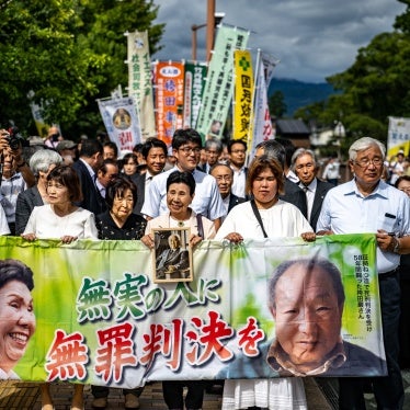 Iwao Hakamata, a former professional boxer who was sentenced to death in 1968 for the 1966 murder of a family of four, was acquitted on September 26, 2024 following a retrial. His sister, Hideko Hakamata (C), holds a banner reading "innocent man, not guilty verdict" as she arrives at the Shizuoka District Court that day. 