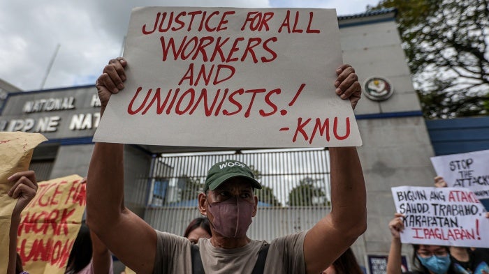 Workers hold a rally outside police headquarters in Quezon City, Philippines, in response to the brutal killing the previous week of  labor organizer Jude Thaddeus Fernandez from Kilusang Mayo Uno, October 5, 2023. 