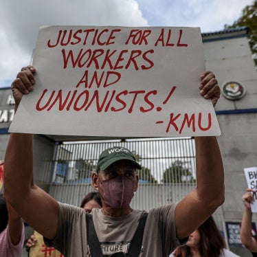 Workers hold a rally outside police headquarters in Quezon City, Philippines, in response to the brutal killing the previous week of  labor organizer Jude Thaddeus Fernandez from Kilusang Mayo Uno, October 5, 2023. 