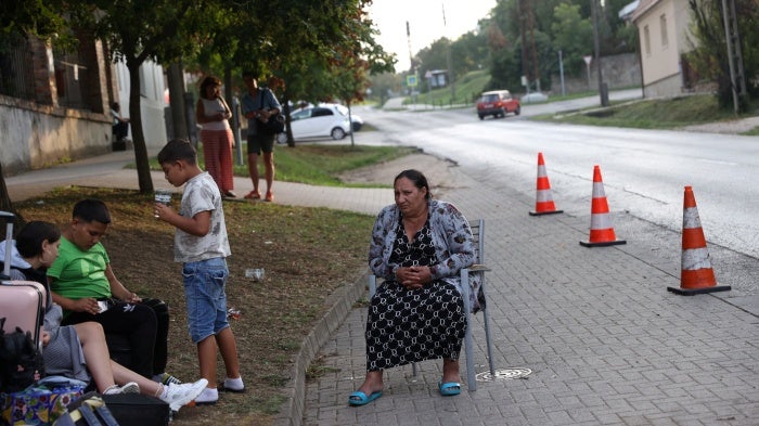 A Ukrainian woman of Roma ethnicity sits on a chair on the street, after losing access to subsidized accommodation in Komárom-Esztergom county, Hungary, August 21, 2024. 