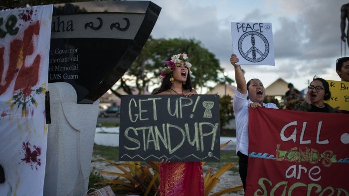 Members of community groups calling for the "de-colonization and de-militarization of Guam" attend a "People for Peace" rally in Hagatna on August 14, 2017.