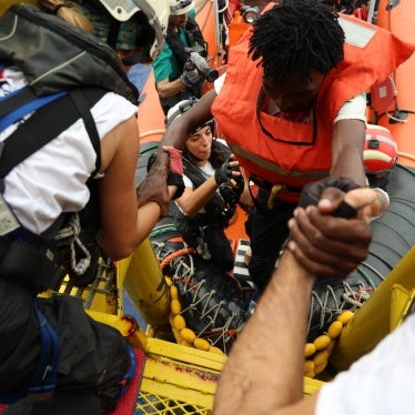 Médécins Sans Frontières rescue crew help a man on board following a rescue in the central Mediterranean Sea, September 20, 2024. 