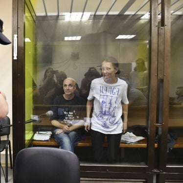 Defendants Alexander Dotsenko (L) and Anastasia Dyudyayeva, in a courtroom hearing accused of incitement to terrorism for leaving anti-war notes in a supermarket, St. Petersburg, Russia, July 18, 2024.