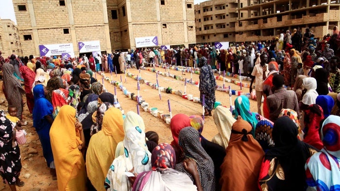 Displaced people gather to receive free breakfast meals at a neighborhood in Omdurman city, Sudan, August 1, 2024. 