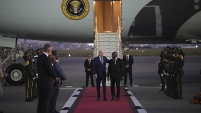 US President Joe Biden is greeted by Angolan Foreign Minister Tete Antonio as he arrives at Quatro de Fevereiro international airport in Luanda, Angola, December 2, 2024.