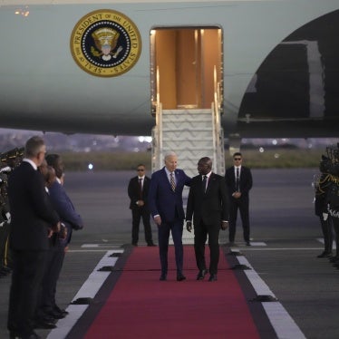 US President Joe Biden is greeted by Angolan Foreign Minister Tete Antonio as he arrives at Quatro de Fevereiro international airport in Luanda, Angola, December 2, 2024.