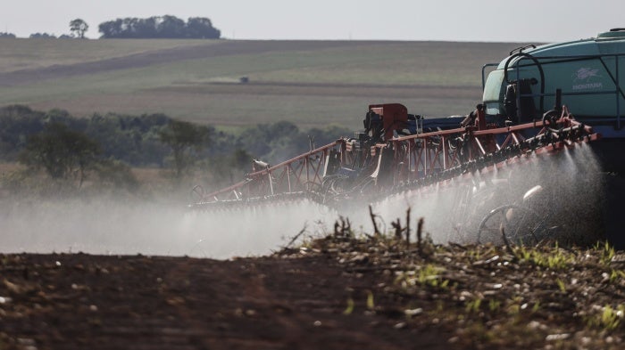 A worker applies fungicide after harvesting soybeans in Campo Mourão, in the Central-West Region of Paraná, Brazil, October 14, 2021. 