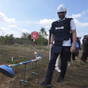 Demining equipment shown next to a deminer in training. 