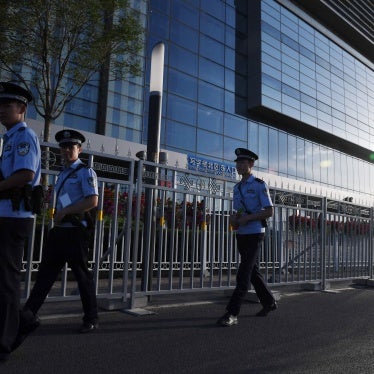 Police officers patrol outside the China National Convention Center in Beijing, May 13, 2017. (