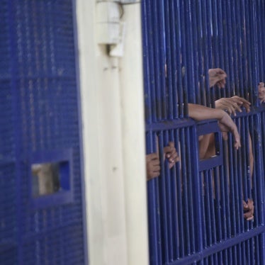 Detainees stand behind cell bars at the police immigration detention center in Bangkok, Thailand, January 21, 2019.