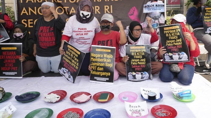 Activists during a protest and hunger strike demanding that parliament to pass a bill to protect domestic workers, at the parliament in Jakarta, Indonesia, August 14, 2023.