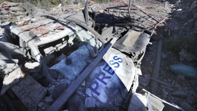 Two destroyed vehicles and a demolished building where three journalists were killed in an Israeli airstrike at the Hasbaya Village Resort, in sourthern Lebanon on October 25, 2024.