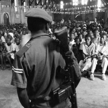 A crowd of mostly Tutsi civilians, seeking protection against Hutu militiamen, sit in the Sainte Famille Catholic church in the then-government controlled part of Kigali, listening to a member of the security services address them. Over several months, ma